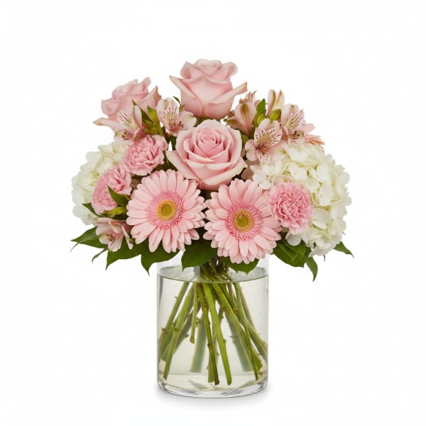 Pink roses and gerbera daisies in a clear glass vase