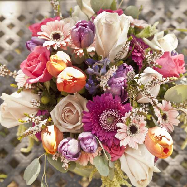 Colorful bouquet with roses, tulips, and daisies