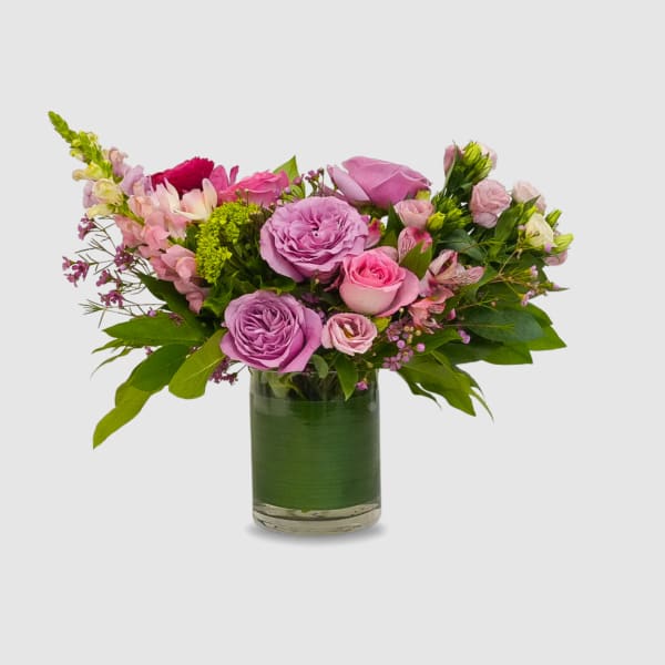 Pink and lavender roses in a glass vase