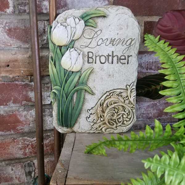 Decorative memorial stone with white tulips and the words "Loving Brother"