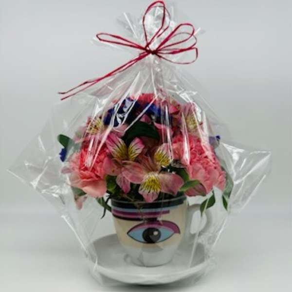Wrapped flower arrangement in a mug with an eye design