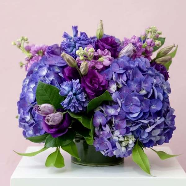 Purple and blue hydrangea bouquet in a glass vase