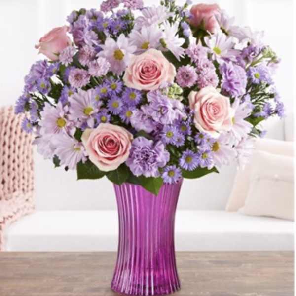 Pink roses and lavender daisies in a purple vase
