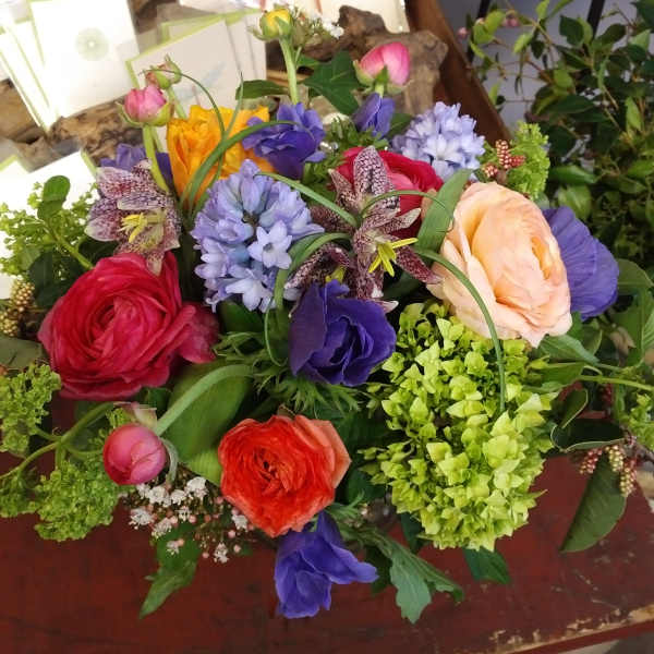 Colorful mixed bouquet with ranunculus, hyacinth, and lilies