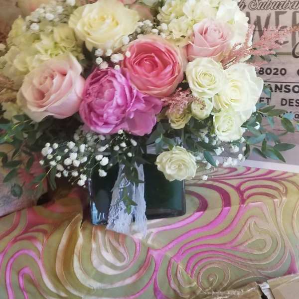 Bouquet of pink and white roses in a black vase