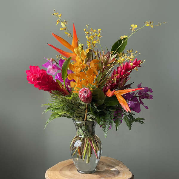 Bright tropical bouquet in a clear glass vase
