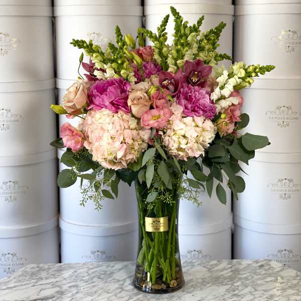 Pink and white mixed bouquet in a tall glass vase