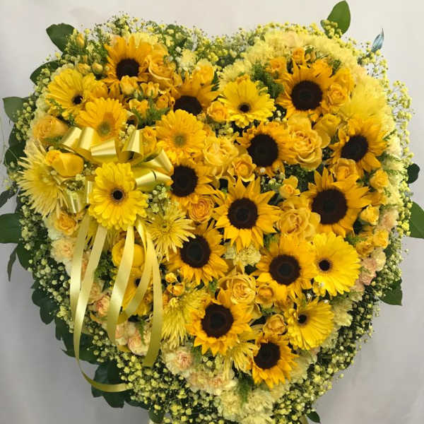 Heart-shaped yellow floral standing spray with sunflowers and roses