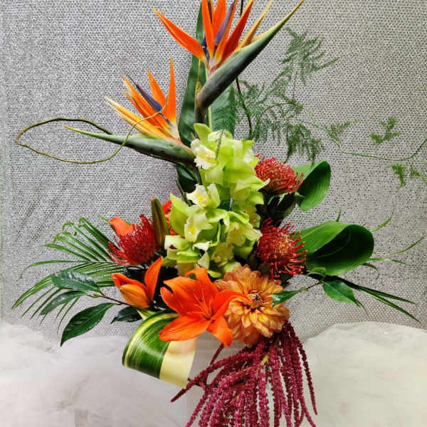 Tall tropical bouquet with orange bird of paradise and orchids