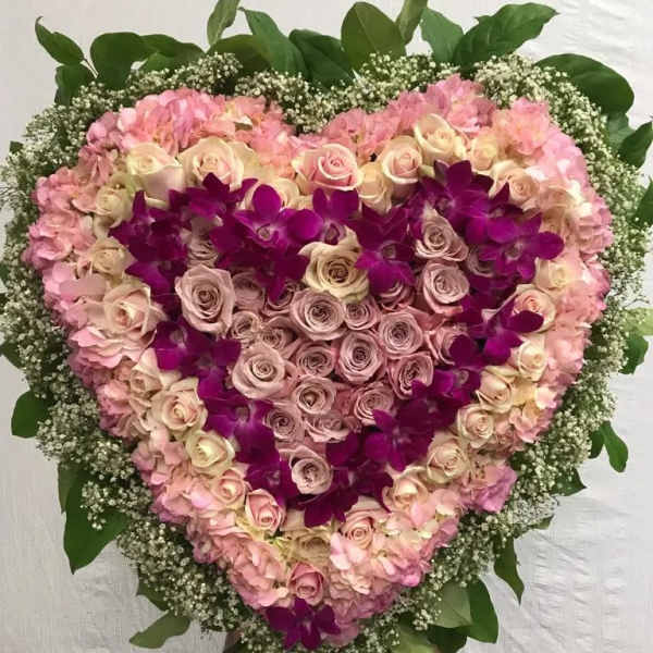 Heart-shaped floral spray with pink roses and purple orchids