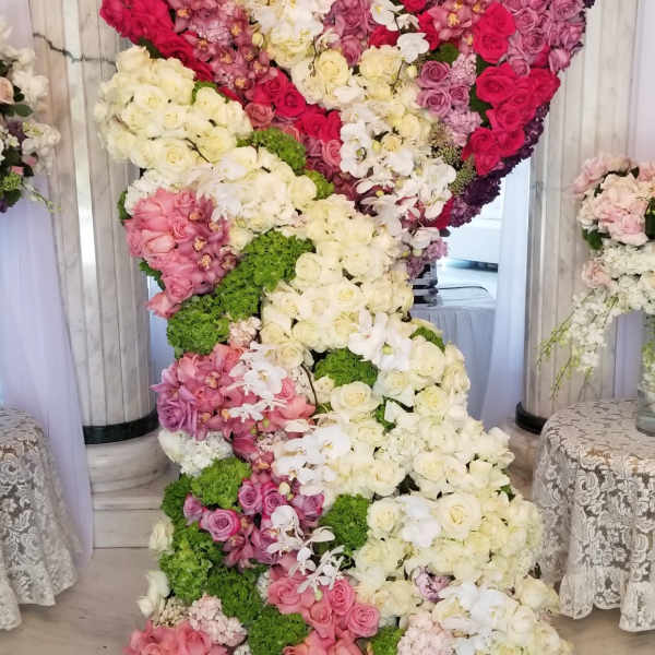 Large floral display shaped like a number 2 with pink, white, and purple flowers