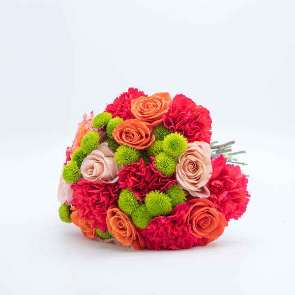 Hand-tied bouquet of orange and blush roses, red carnations, and green button mums