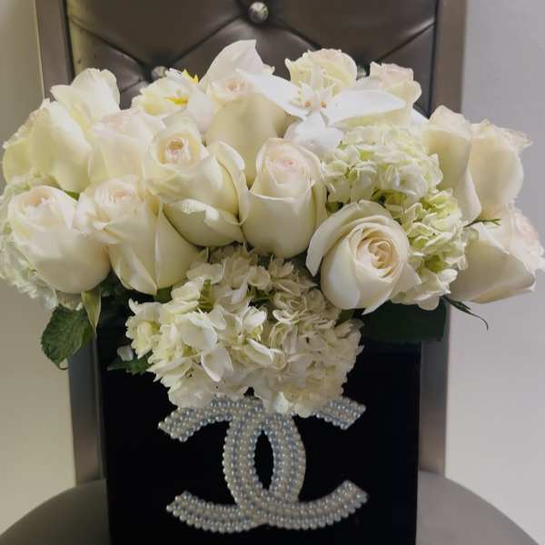 White rose bouquet in a black box with a pearl Chanel logo