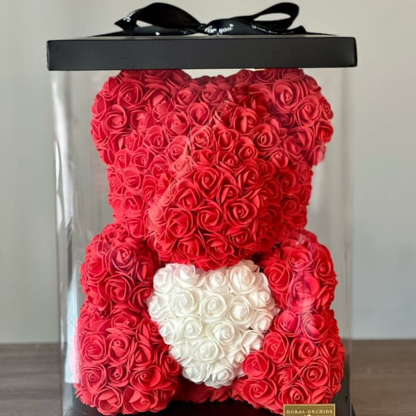 Red rose teddy bear in a clear gift box with a white heart
