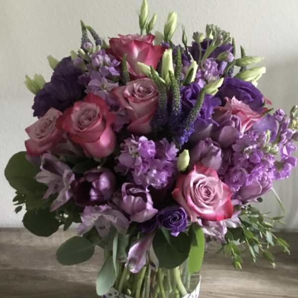Bouquet of pink and purple flowers in a patterned box