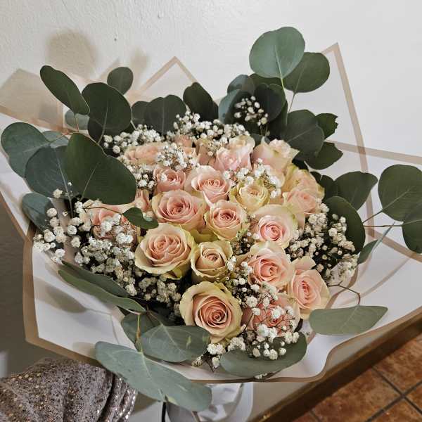Bouquet of pale pink roses with white baby's breath and eucalyptus
