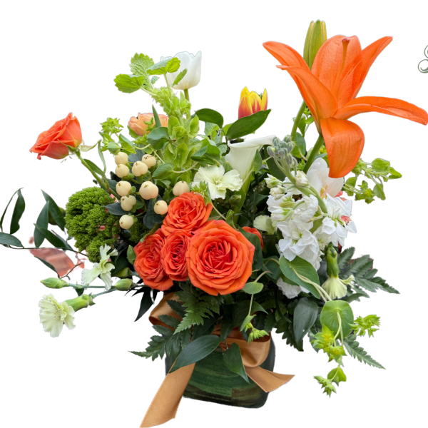 Orange lilies and roses arranged in a vase with white flowers