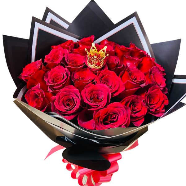Bouquet of red roses wrapped in black paper with a gold crown accent