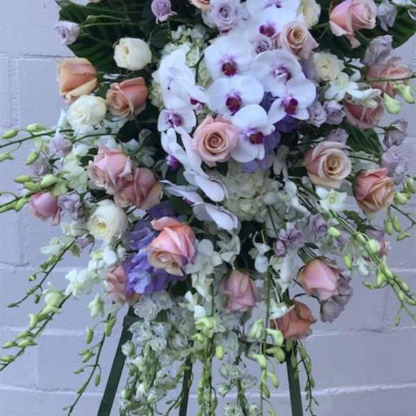 Large pastel bouquet with roses and orchids on a stand