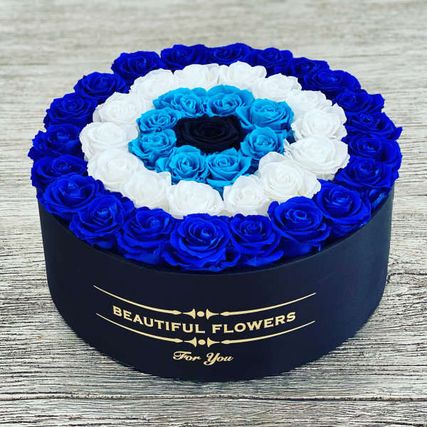 Round box of blue, white, and turquoise roses