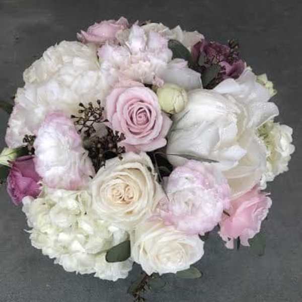 Round bouquet of pale pink and white roses with white blooms