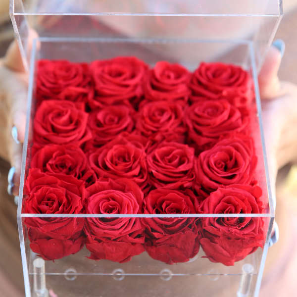 Clear box filled with red roses