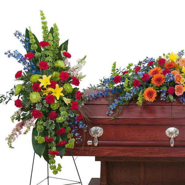 Casket surrounded by colorful funeral flower sprays