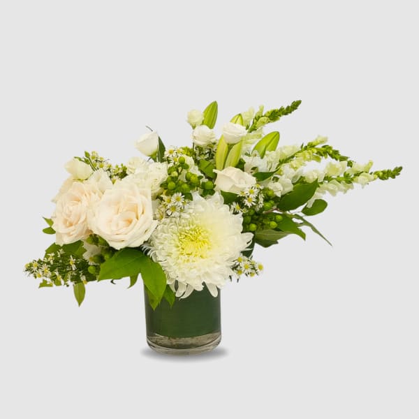 White roses and chrysanthemums in a glass vase