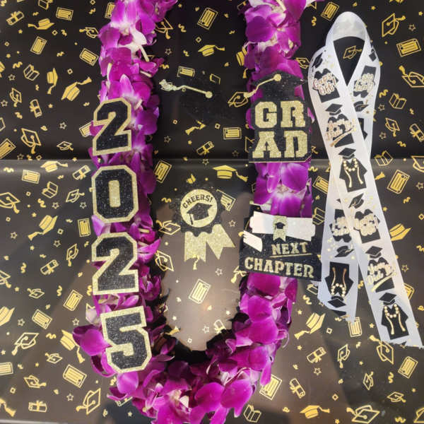 Purple orchid graduation lei with 2025 and grad charms on black background with gold caps.