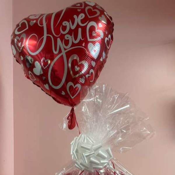 Gift basket with a teddy bear, heart balloon, and love-themed decorations