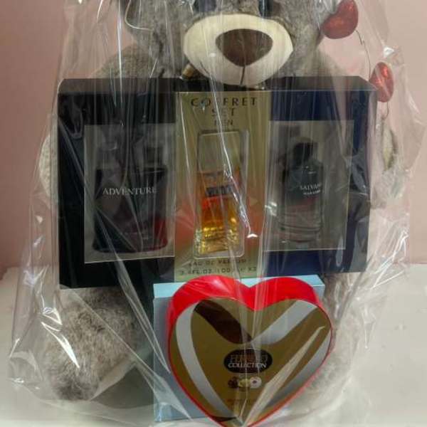 Gift basket with a teddy bear, cologne set, and heart-shaped chocolate box