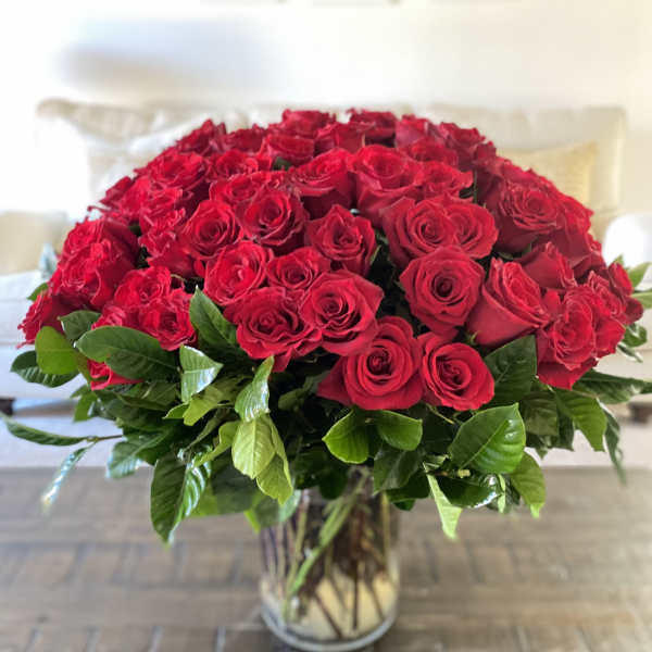 Large bouquet of red roses in a clear glass vase