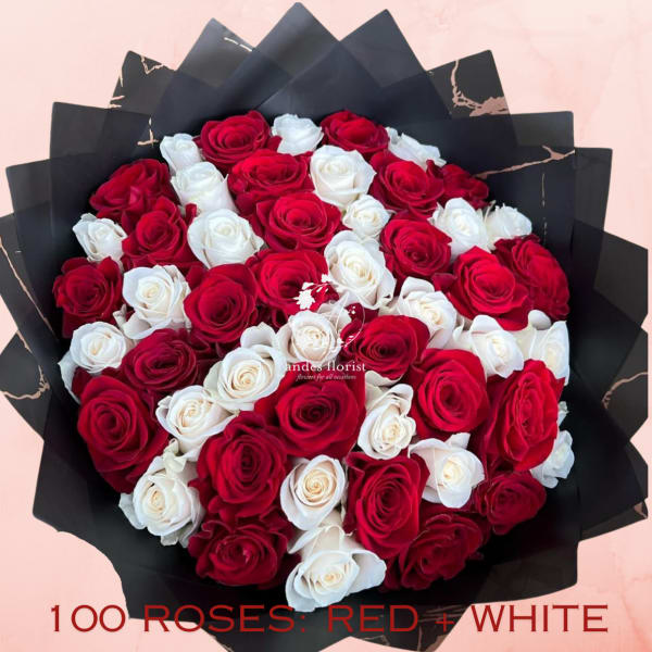 Bouquet of red and white roses wrapped in black paper