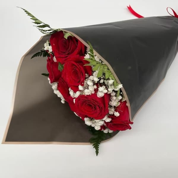 Bouquet of red roses with baby's breath wrapped in black paper