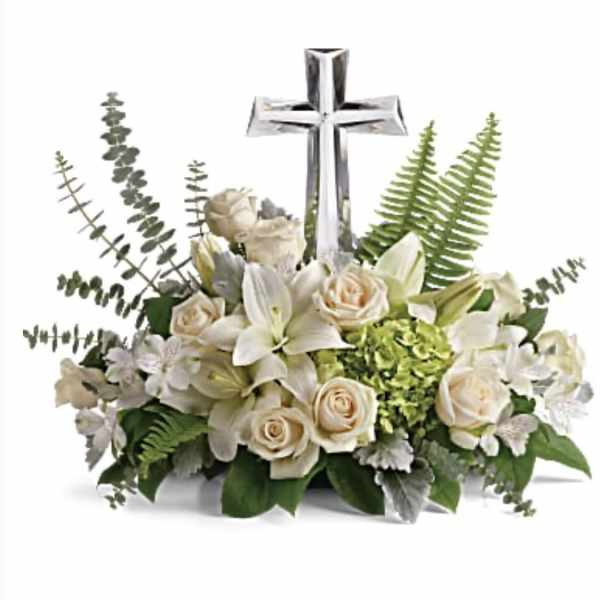 White floral arrangement with a silver cross centerpiece