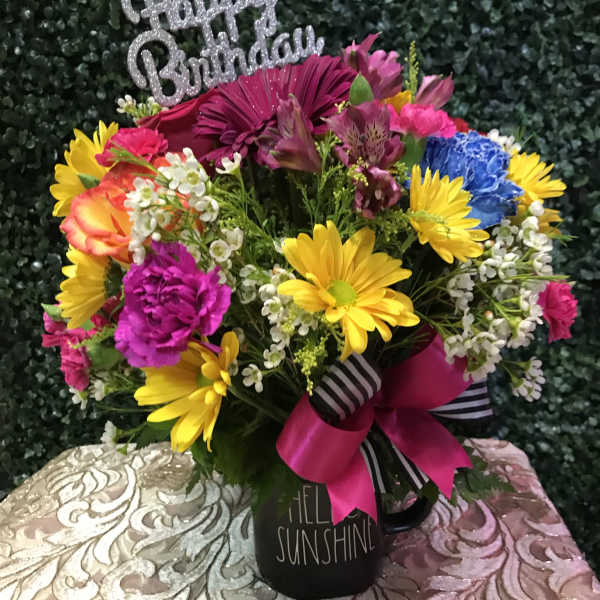 Colorful birthday bouquet in a black mug with a glittery topper