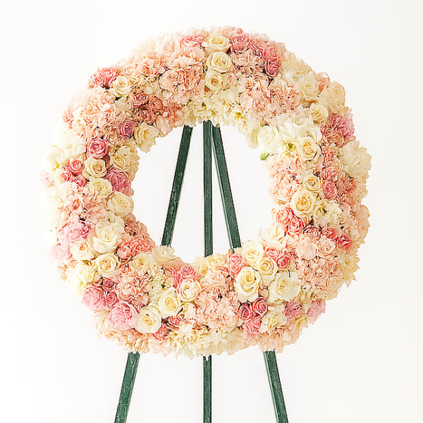 Pastel rose wreath on a green easel stand
