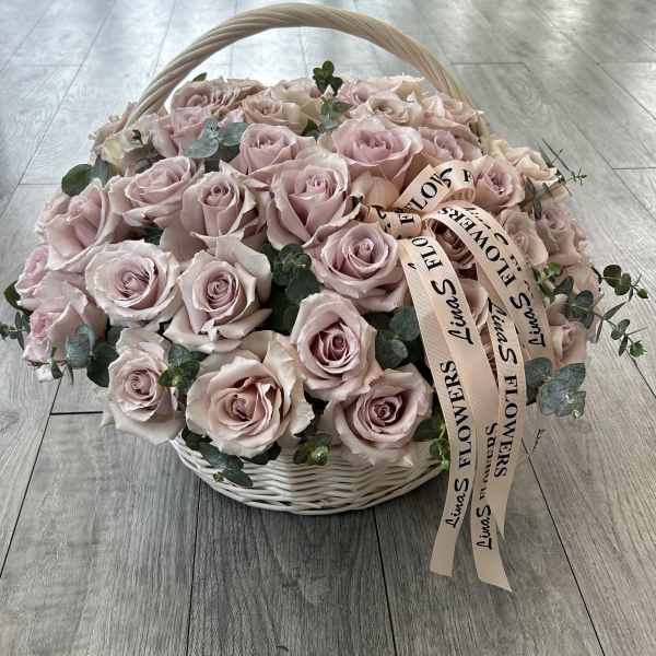 Basket of pale pink roses with eucalyptus and ribbon
