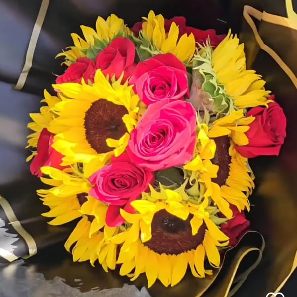 Bouquet of pink roses and yellow sunflowers wrapped in black paper