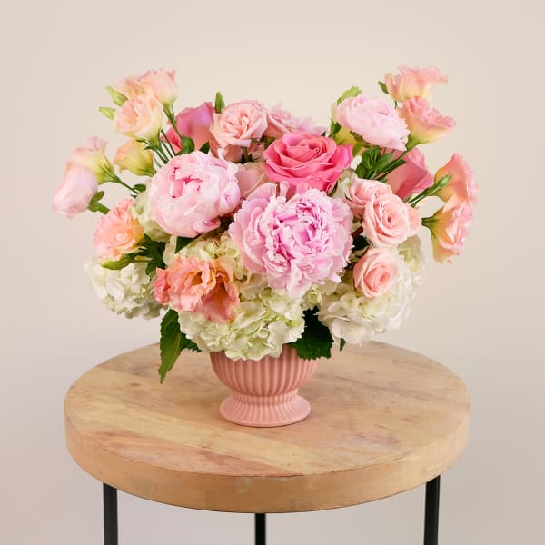 Pink and peach bouquet in a ribbed pink vase