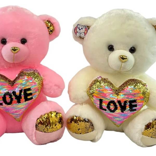 Pair of plush teddy bears, one pink and one cream, holding sequin LOVE hearts with gold accents.