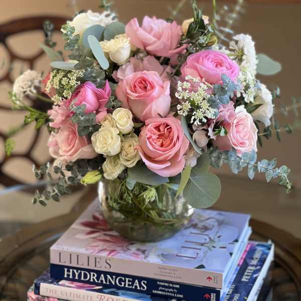 Pink and white rose bouquet in a glass vase