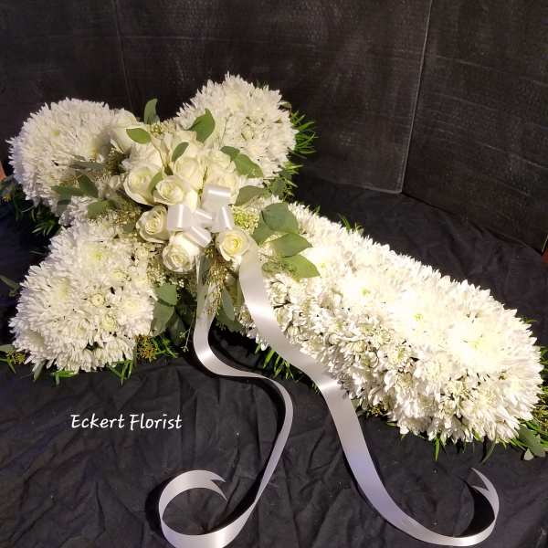 White floral spray with roses and chrysanthemums tied with a white ribbon