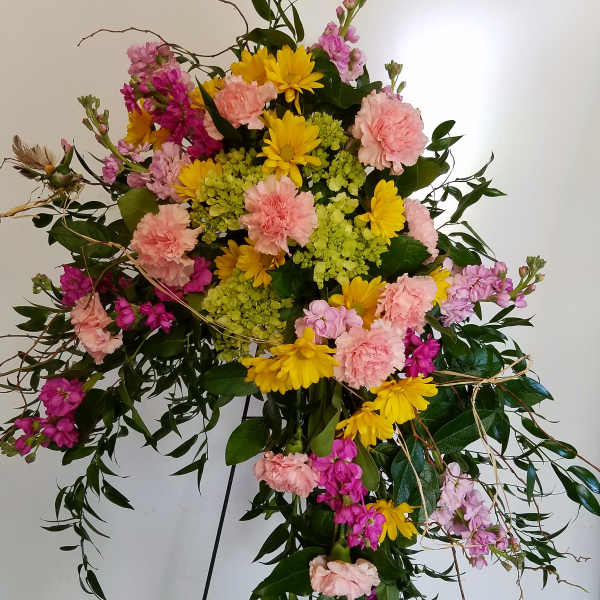 Standing floral spray with pink, yellow, and lavender blooms