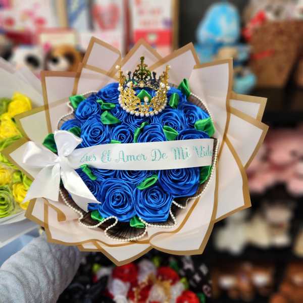 Blue rose bouquet with a crown topper and white ribbon
