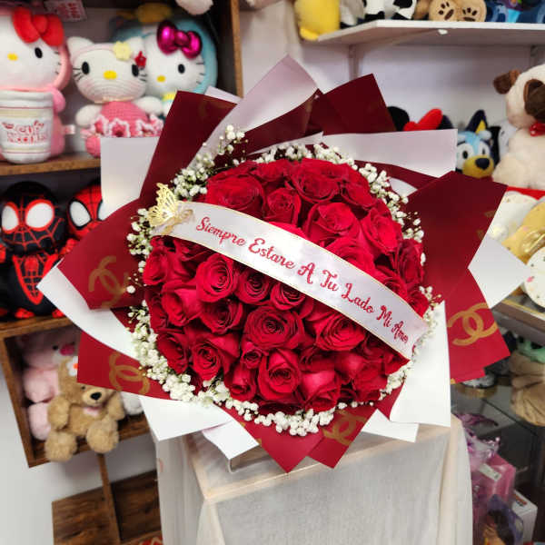Bouquet of red roses with a ribbon and white baby's breath
