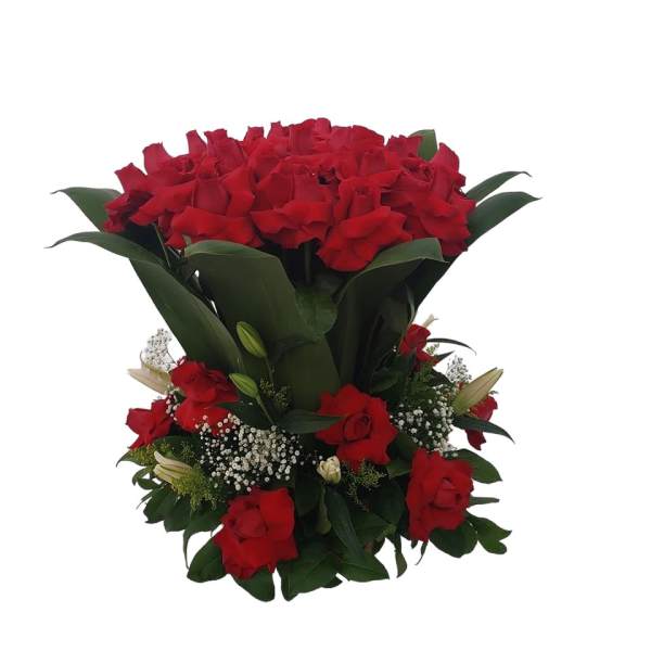 Red rose bouquet with white filler flowers and dark green leaves