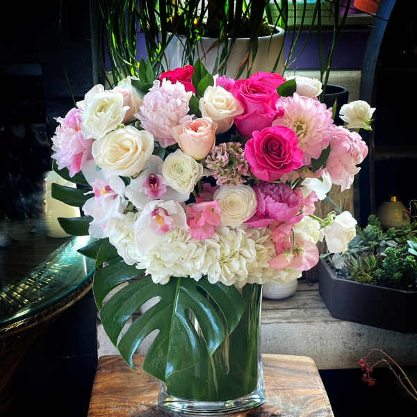 Pink and white floral arrangement in a clear glass vase