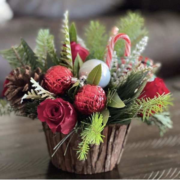 Holiday basket with red roses, pinecones, and candy cane ornaments
