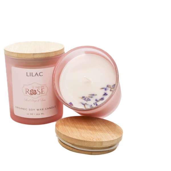 Pink lilac-scented candle in a glass jar with a wooden lid